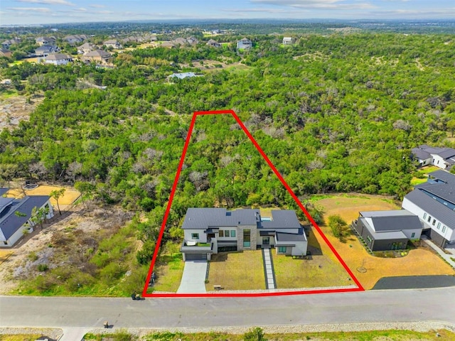 birds eye view of property with a forest view