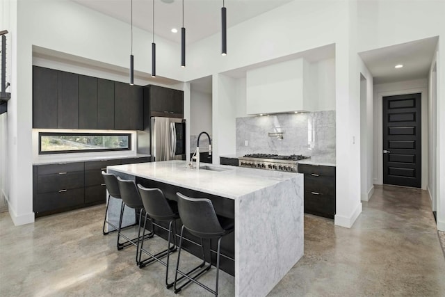 kitchen featuring finished concrete floors, modern cabinets, appliances with stainless steel finishes, and a sink