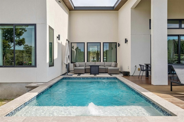 view of pool with a wooden deck and an outdoor living space