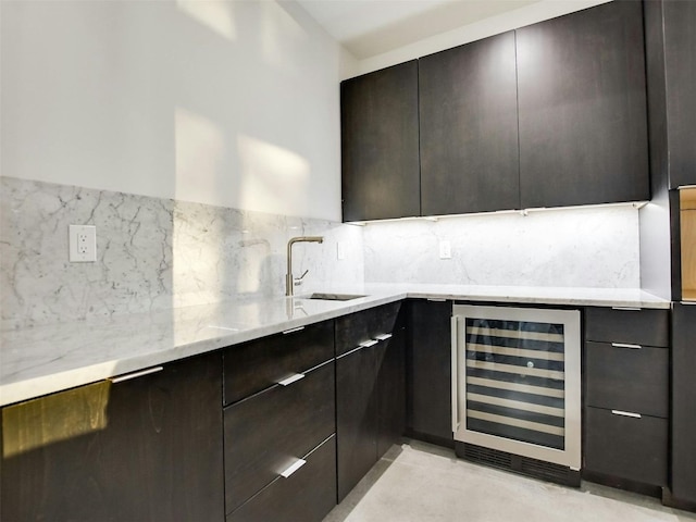 kitchen with wine cooler, modern cabinets, a sink, and decorative backsplash