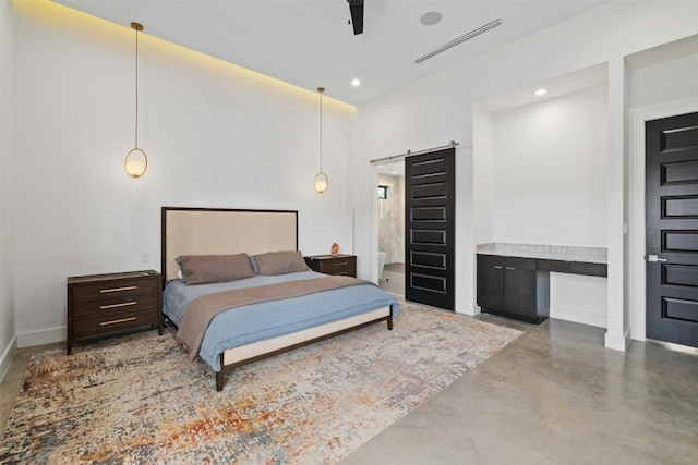 bedroom with a barn door, recessed lighting, visible vents, baseboards, and finished concrete floors