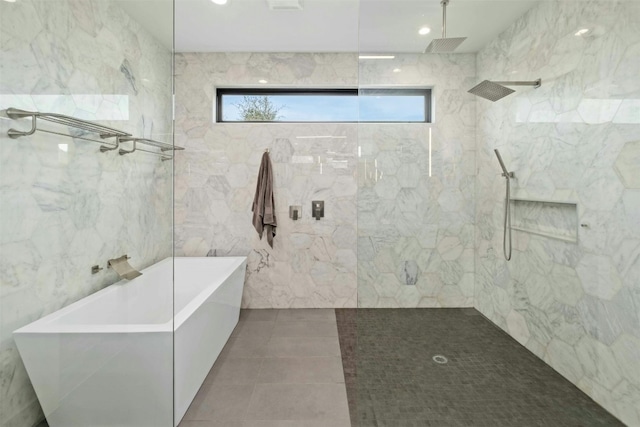 full bath with tile walls, recessed lighting, a walk in shower, tile patterned flooring, and a freestanding tub