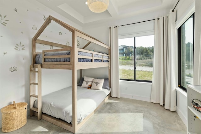 bedroom with concrete flooring, multiple windows, coffered ceiling, and baseboards