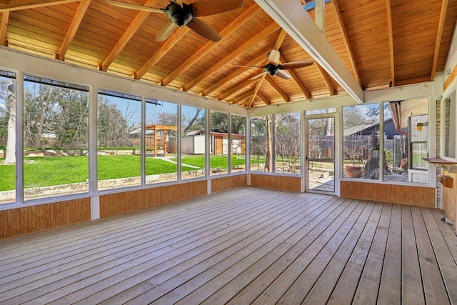 unfurnished sunroom featuring ceiling fan, lofted ceiling with beams, and wood ceiling