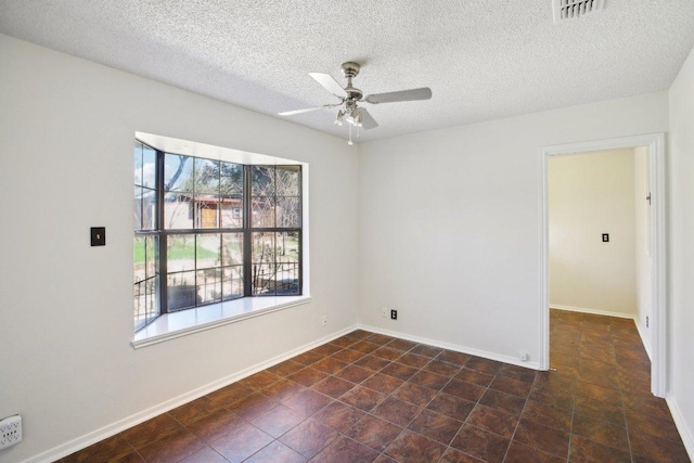 unfurnished room with baseboards, a textured ceiling, visible vents, and a ceiling fan