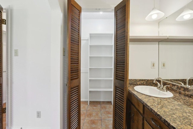 bathroom featuring a closet, tile patterned flooring, and vanity