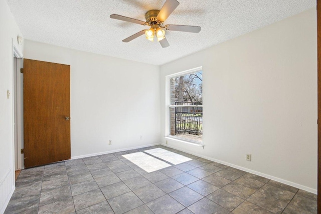 unfurnished room with a textured ceiling, ceiling fan, and baseboards