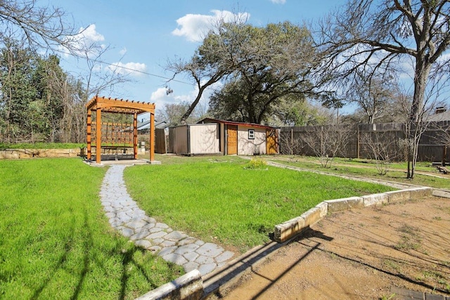 view of yard featuring a storage shed, a fenced backyard, a pergola, and an outdoor structure