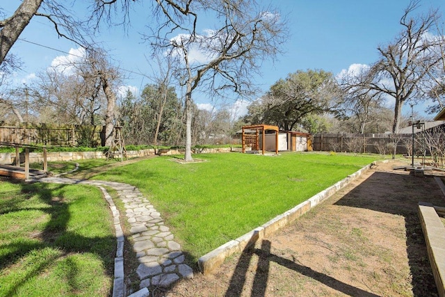 view of yard with an outbuilding and a fenced backyard