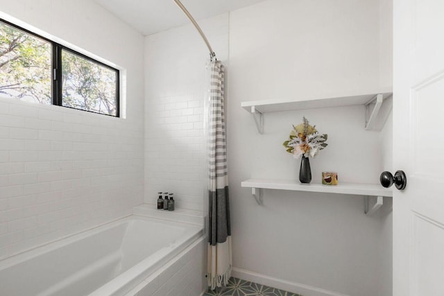 full bathroom featuring shower / bath combination with curtain and baseboards