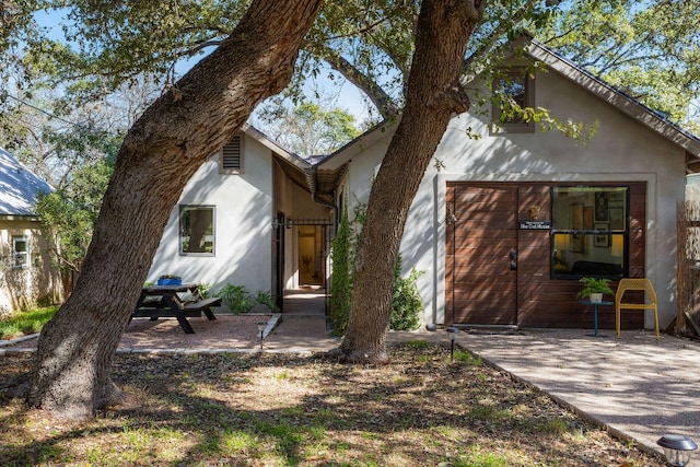 view of front of home with a patio and stucco siding