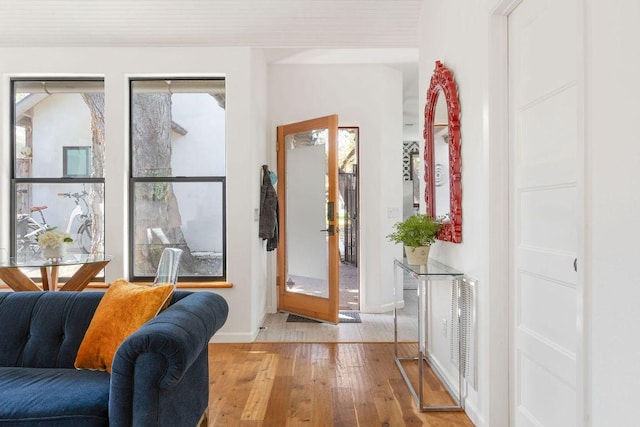 foyer with light wood-style flooring and visible vents