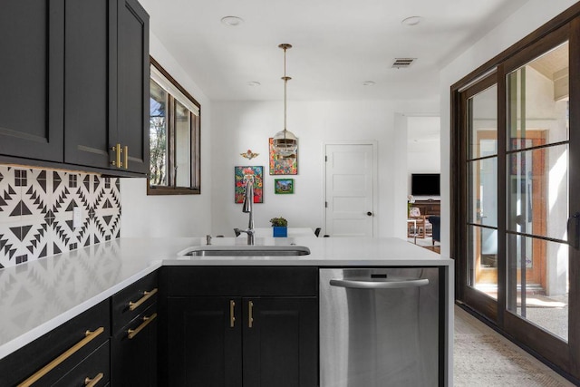 kitchen featuring stainless steel dishwasher, a sink, visible vents, and a healthy amount of sunlight