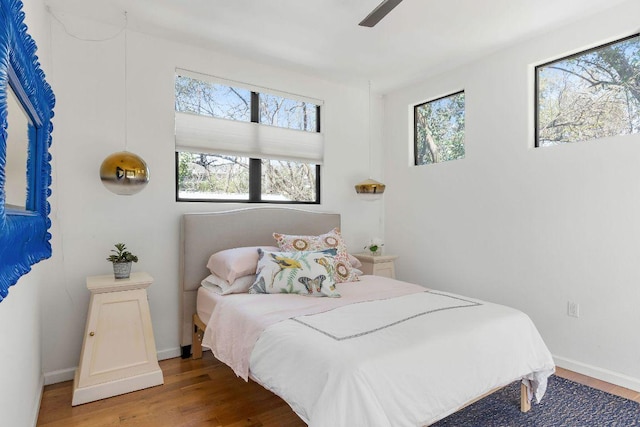 bedroom with baseboards and wood finished floors