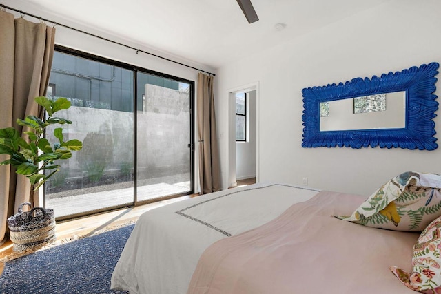 bedroom featuring access to exterior, multiple windows, and a ceiling fan