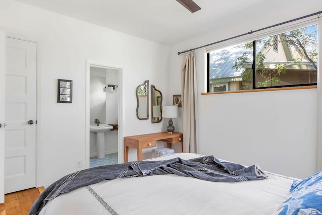 bedroom featuring multiple windows and wood finished floors