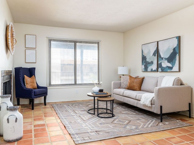 living area featuring baseboards and tile patterned floors