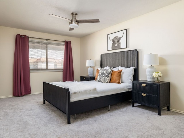 carpeted bedroom with a ceiling fan and baseboards