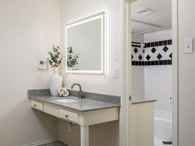 bathroom featuring shower / bathing tub combination, a sink, and visible vents