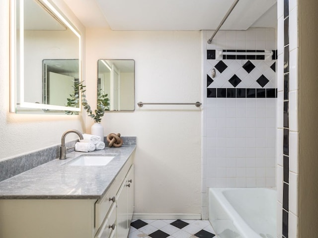 full bath with bathtub / shower combination, vanity, and baseboards