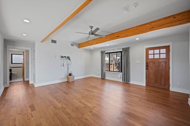 unfurnished living room with visible vents, beam ceiling, wood finished floors, recessed lighting, and baseboards