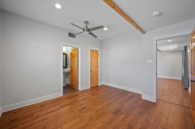 unfurnished bedroom with beamed ceiling, visible vents, wood finished floors, recessed lighting, and baseboards