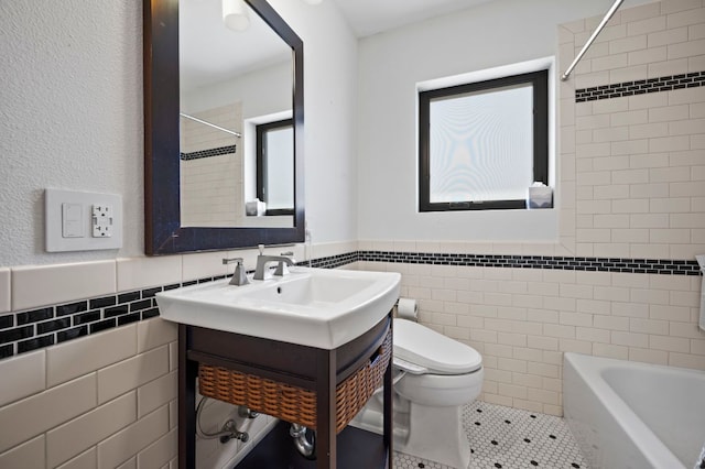 full bathroom featuring tile patterned floors, toilet, tile walls, wainscoting, and vanity