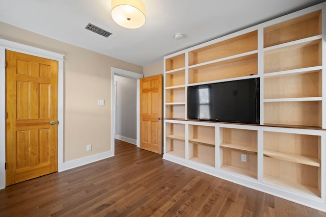 unfurnished living room with visible vents, baseboards, and dark wood finished floors