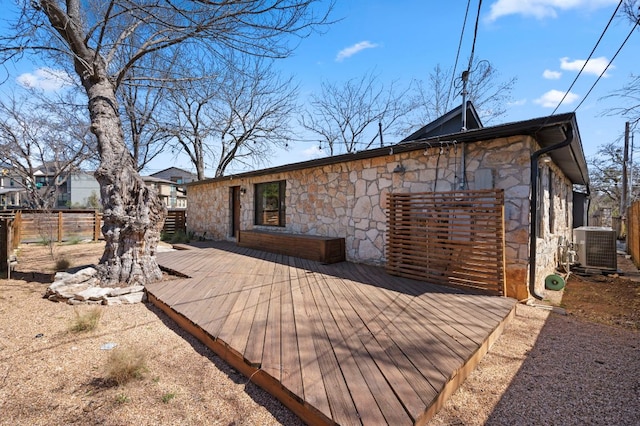 deck featuring central air condition unit and fence