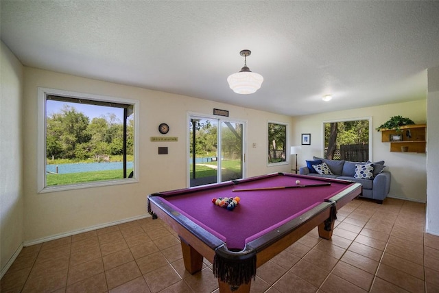 game room with tile patterned flooring, billiards, a textured ceiling, and baseboards