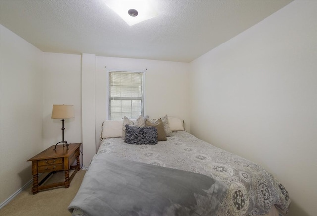 bedroom with light carpet and a textured ceiling