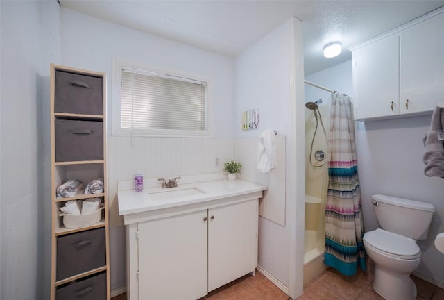 full bathroom featuring toilet, curtained shower, tile patterned flooring, and vanity