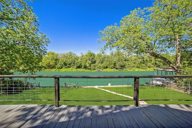 deck with a lawn and fence