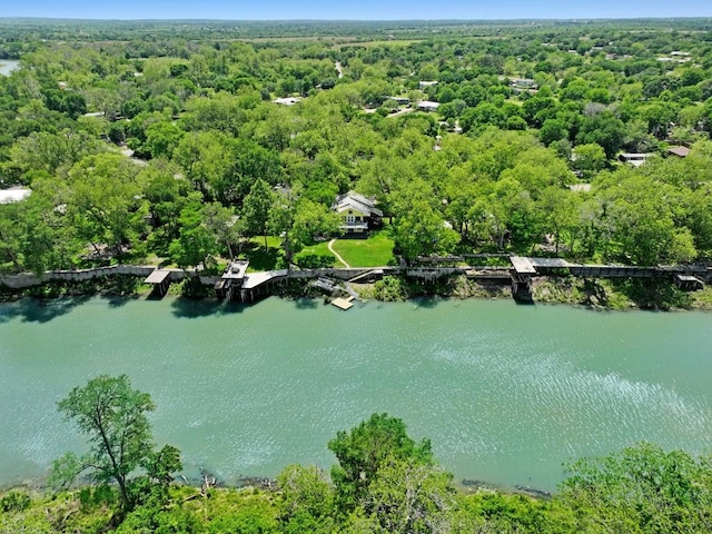 aerial view with a water view and a forest view