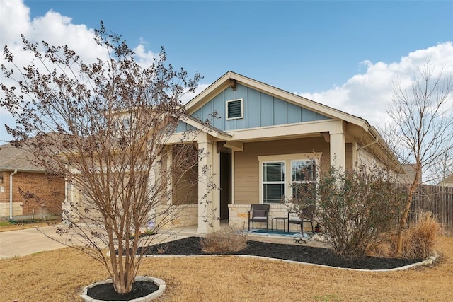 view of front of house with covered porch, concrete driveway, board and batten siding, and a garage