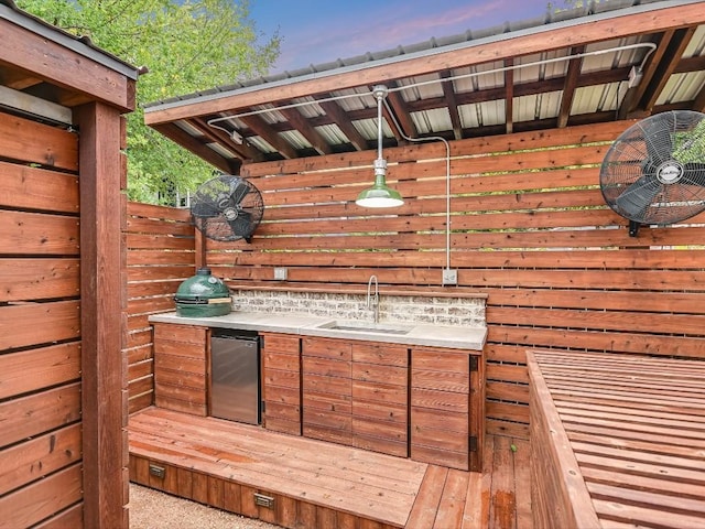 deck with exterior kitchen and a sink