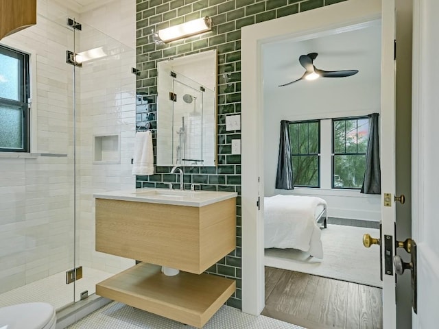 bathroom with a healthy amount of sunlight, ensuite bath, a shower stall, and vanity