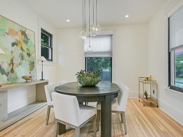 dining room featuring light wood-style floors, recessed lighting, and baseboards