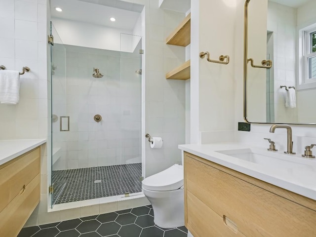 full bathroom featuring toilet, a stall shower, vanity, and recessed lighting