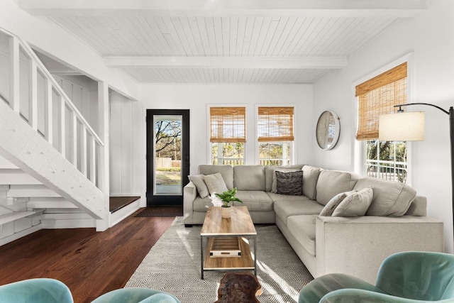 living room featuring beamed ceiling, wood finished floors, and a wealth of natural light