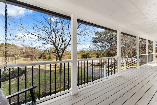 wooden terrace with a lawn