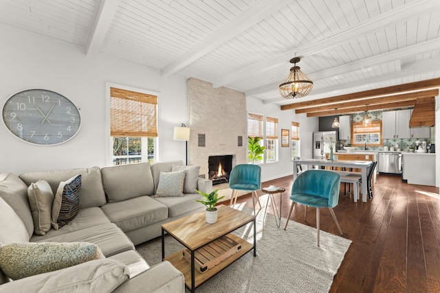 living room featuring a large fireplace, baseboards, wooden ceiling, dark wood-type flooring, and beamed ceiling