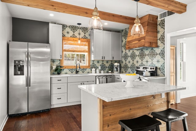 kitchen featuring dark wood-style flooring, a sink, visible vents, appliances with stainless steel finishes, and beam ceiling