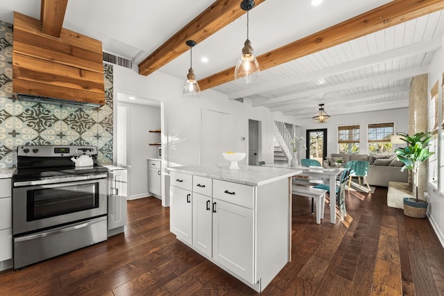 kitchen with open floor plan, dark wood-type flooring, decorative backsplash, and stainless steel range with electric cooktop