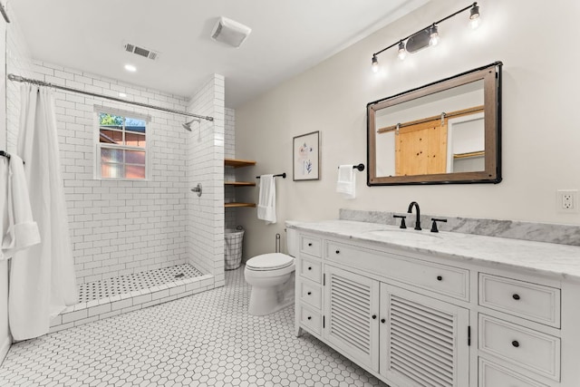 full bath with visible vents, tiled shower, vanity, and toilet