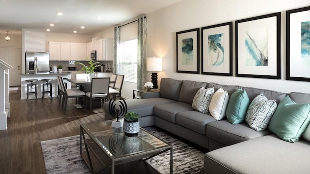 living room with recessed lighting and dark wood finished floors