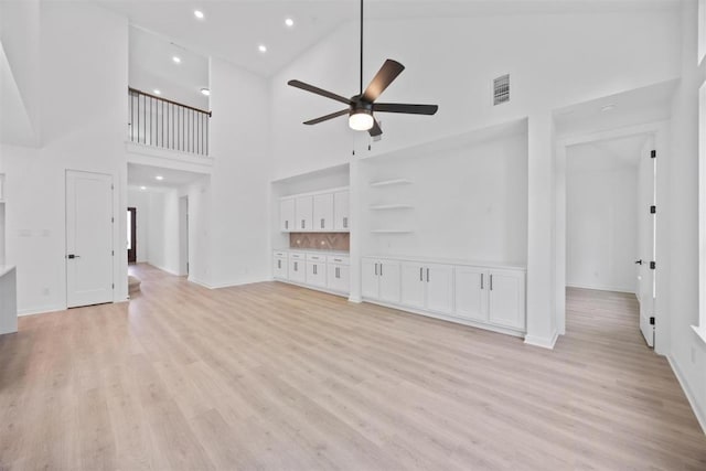 5804 Kelly Kyle Ave, Georgetown, TX 78628 - unfurnished living room featuring high vaulted ceiling, ceiling fan, light wood finished floors, and recessed lighting