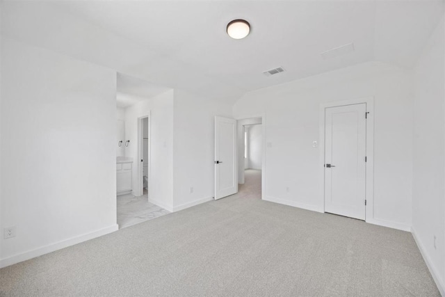 5804 Kelly Kyle Ave, Georgetown, TX 78628 - unfurnished bedroom featuring light colored carpet, vaulted ceiling, and connected bathroom