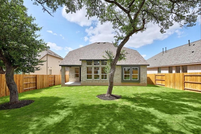 5804 Kelly Kyle Ave, Georgetown, TX 78628 - back of house with a fenced backyard, a shingled roof, and brick siding
