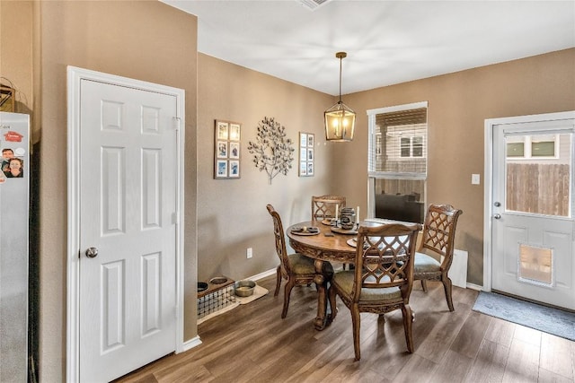 dining room with wood finished floors and baseboards